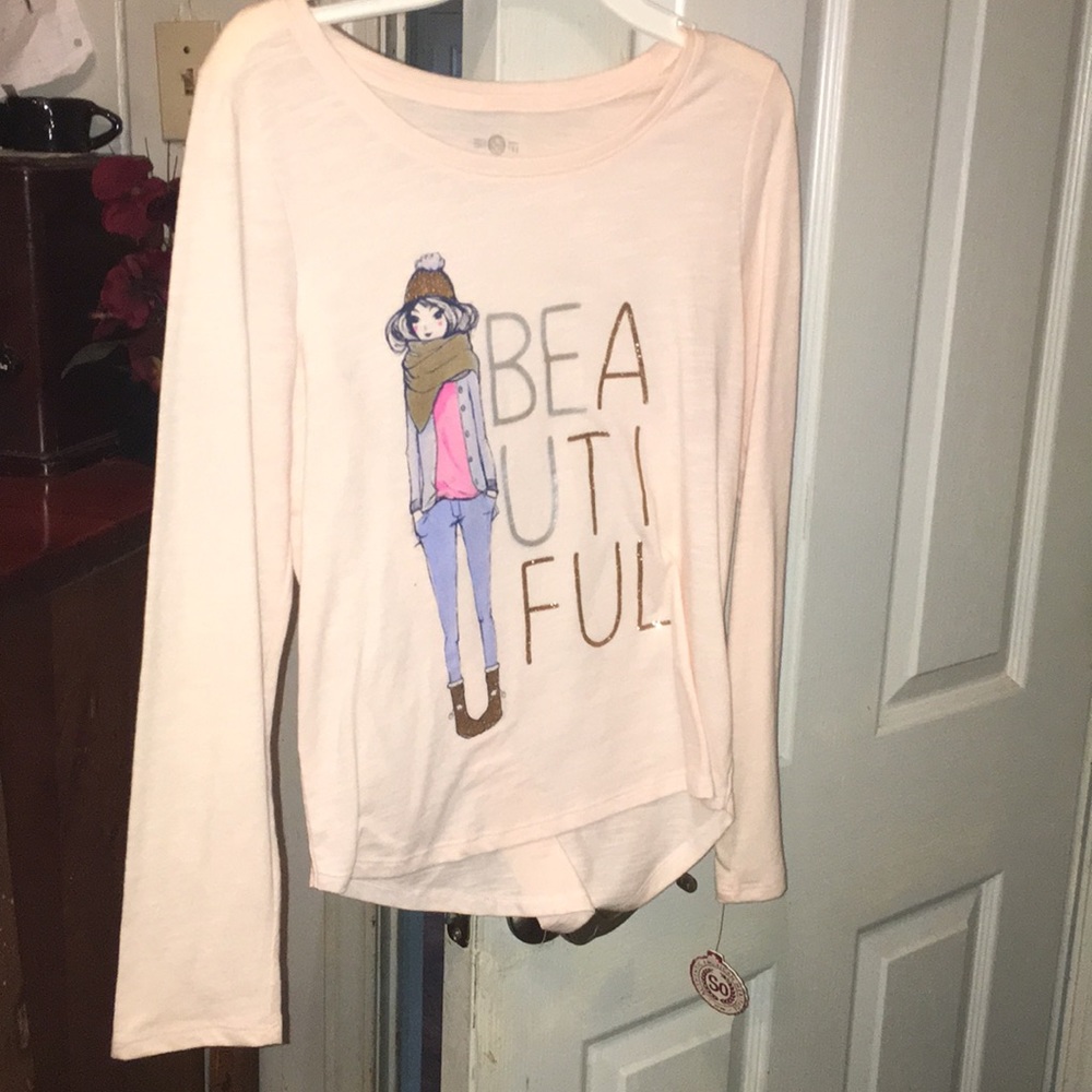 A pink long sleeve shirt that says “beautiful”